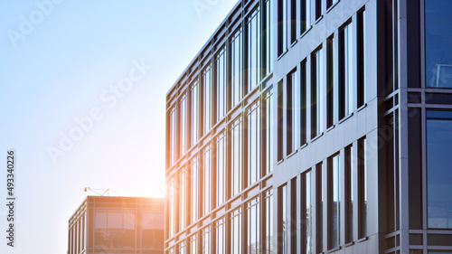 Modern office building in the city with windows and steel and aluminum panels wall. Contemporary commercial architecture, vertical converging geometric lines. 