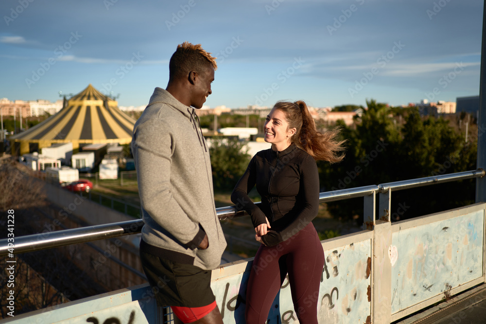 Cheerful diverse athletes on bridge in city Cheerful diverse athletes on bridge in city