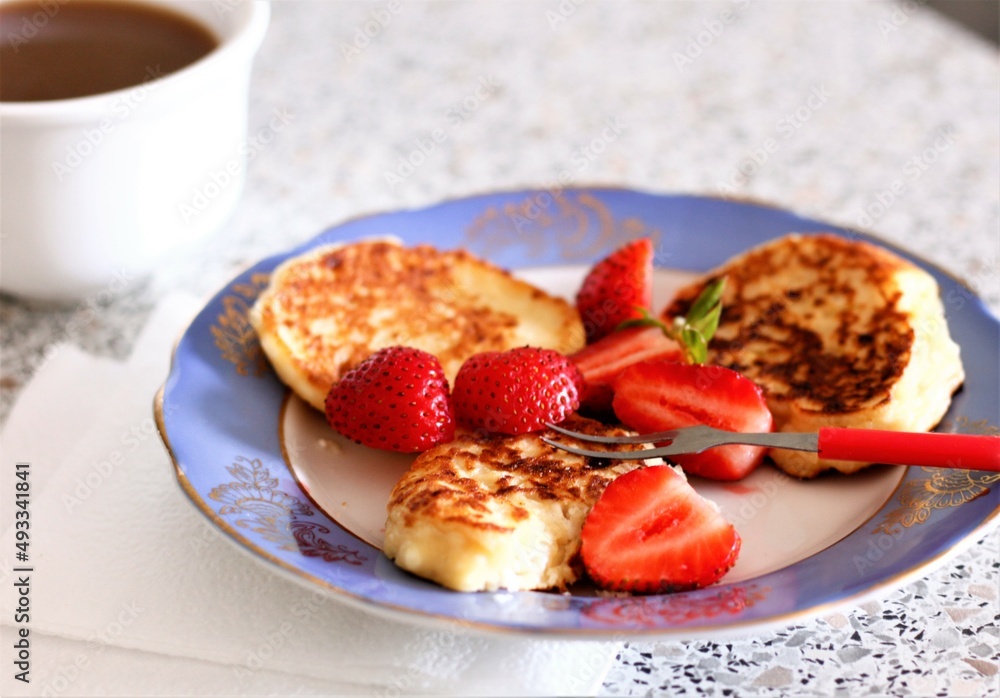 Closeup pancake with strawberries and cup of coffee milk food dessert breakfast morning beverage drink cappuccino latte caffeine plate berry plate fork nobody tasty pastry bakery Closeup pancake with strawberries and cup of coffee milk food dessert breakfast morning beverage drink cappuccino latte caffeine plate berry plate fork nobody tasty pastry bakery