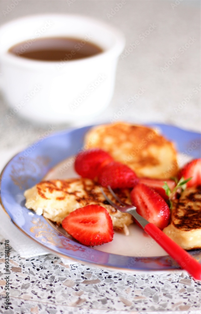 Closeup pancake with strawberries and cup of coffee milk food dessert breakfast morning beverage drink cappuccino latte caffeine plate berry plate fork nobody tasty pastry bakery Closeup pancake with strawberries and cup of coffee milk food dessert breakfast morning beverage drink cappuccino latte caffeine plate berry plate fork nobody tasty pastry bakery
