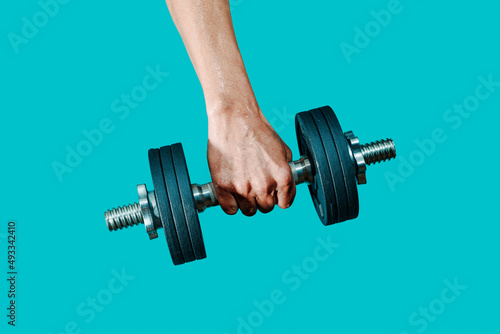 sweating man lifting a dumbbell photo