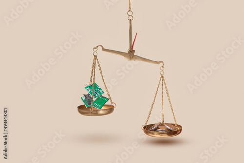 Golden scales with coins and microchips
