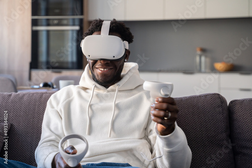 Excited Man Using 3D Glasses At Home photo