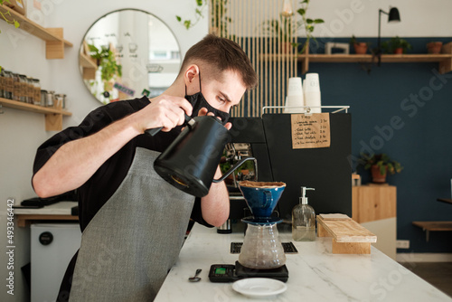 Barista making specialty coffee in a cafe photo