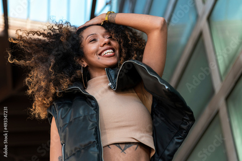 Energetic woman with afro hair showing positive emotion photo