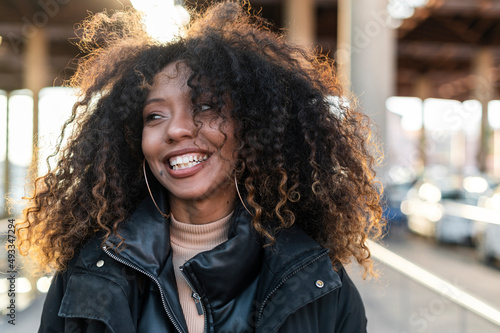 Energetic woman with afro hair showing positive emotion photo