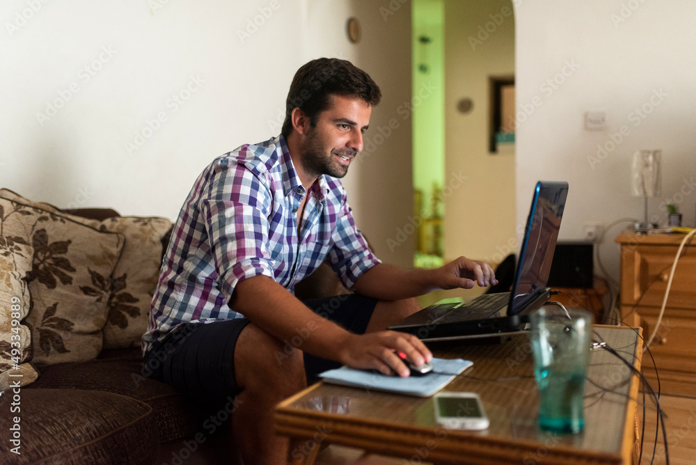 Man working from home using laptop Man working from home using laptop