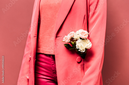 Anonymous woman with flowers in jacket photo