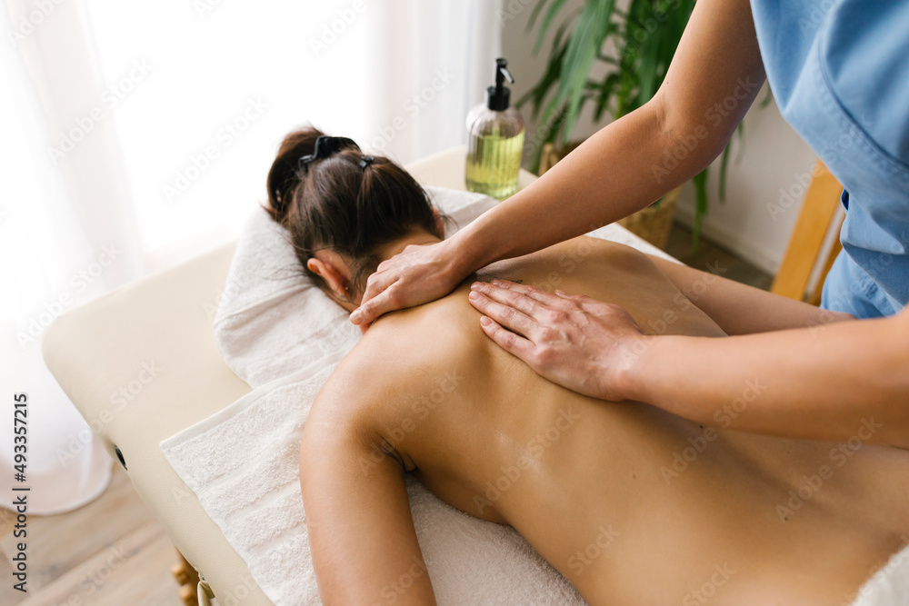 Woman getting a professional back massage Woman getting a professional back massage