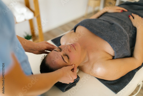 Mature woman at spa having face treatment