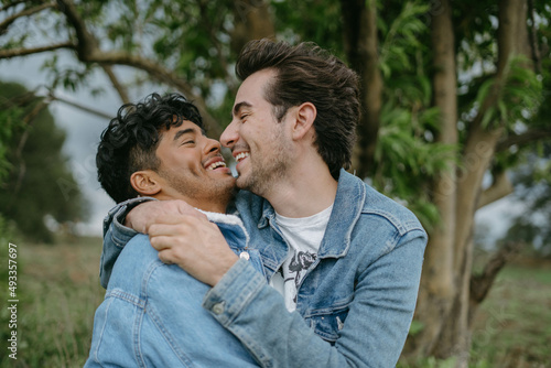 Happy Gay Couple Hugging and Smiling in Nature photo