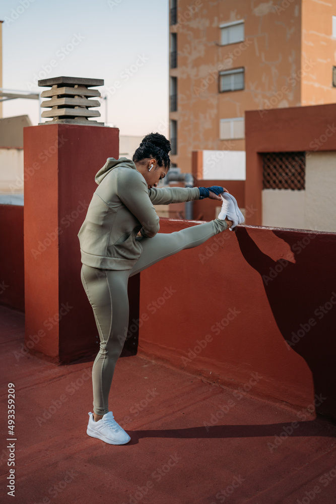 Sportswoman stretching legs during workout Sportswoman stretching legs during workout