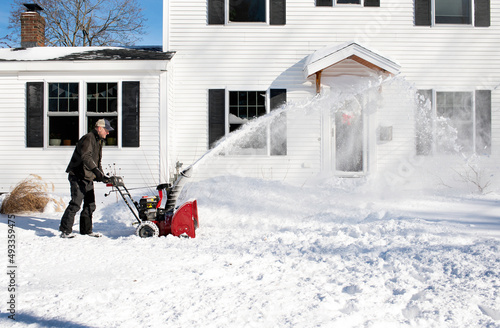 Man Clears Snow Using Snowblower after Big Storm photo