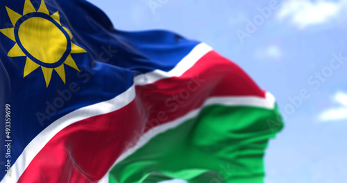 Detail of the national flag of Namibia waving in the wind on a clear day.
