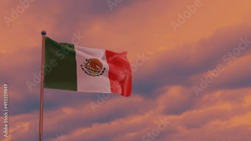 flag of Mexico in the wind against the backdrop of a dramatic sunset sky, National Unity Day