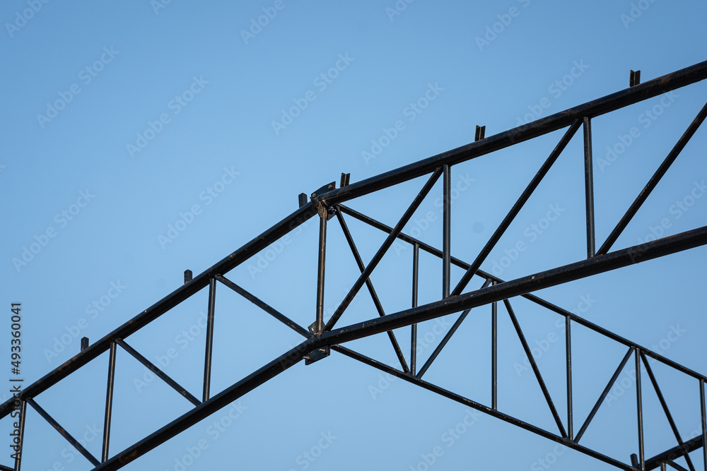 Balance beam and roof structure of the warehouse during it building. Construction building and industrial material photo.