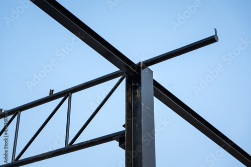 Balance beam and roof structure of the warehouse during it building. Construction building and industrial material photo. photo