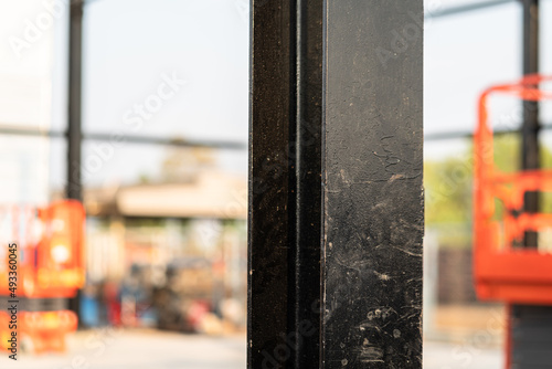 Heavy metal pillar structure of the warehouse building. Industrial construction site and equipment object photo.