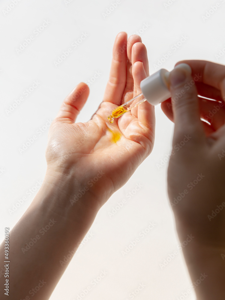 Hand with oil dropper