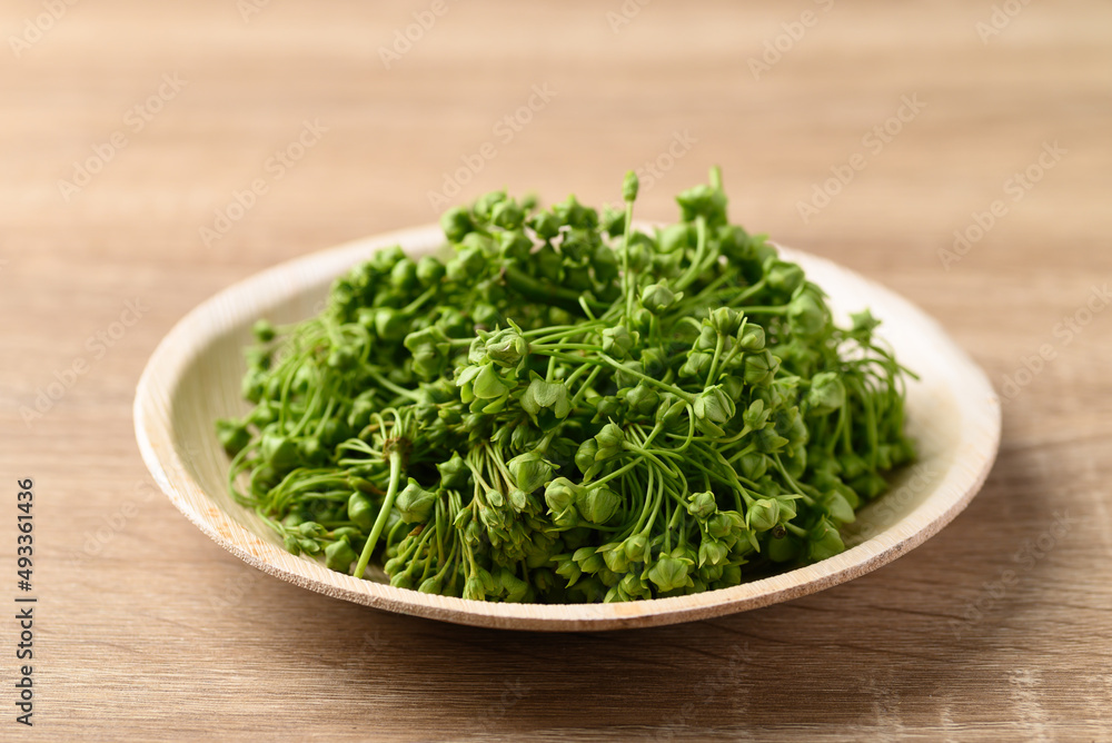 Dregea volubilis flower in natural plate, Edible flower from local farmer market in summer season, Northern of Thailand Dregea volubilis flower in natural plate, Edible flower from local farmer market in summer season, Northern of Thailand