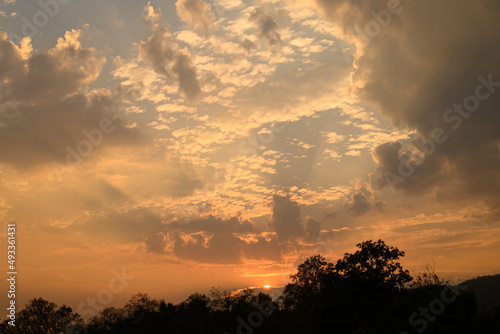 Vanilla sky with cloud and sunlight above trees before sunset, Natural background