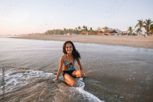 Latina teen similing at the beach photo