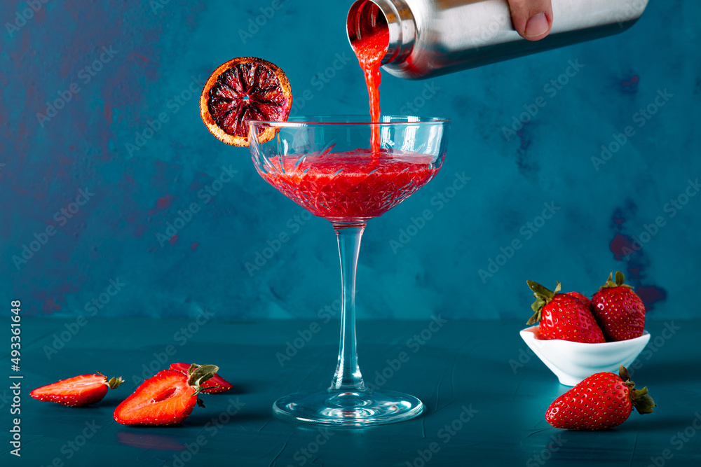 custom made wallpaper toronto digitalAnonymous hand is pouring strawberry cocktail or juice from mug or shaker. Includes copy space.