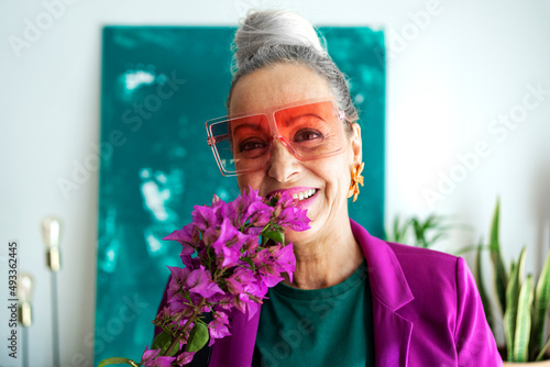 Stylish fashion designer smelling bouquet  photo