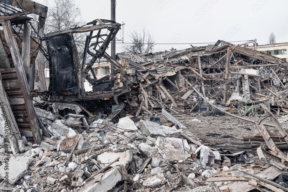 The ruins of a civilian house and the remains of a burned car. Consequence of Russia's missile strike on civilians. Ukraine. (concept of war) The ruins of a civilian house and the remains of a burned car. Consequence of Russia's missile strike on civilians. Ukraine. (concept of war)