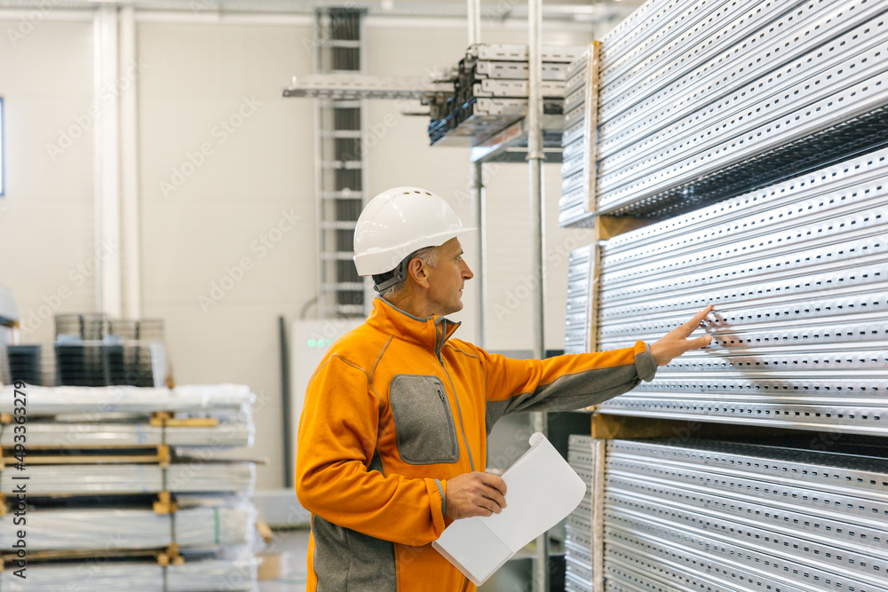 Man Checking Production Statistics Of Aluminium Profiles Man Checking Production Statistics Of Aluminium Profiles