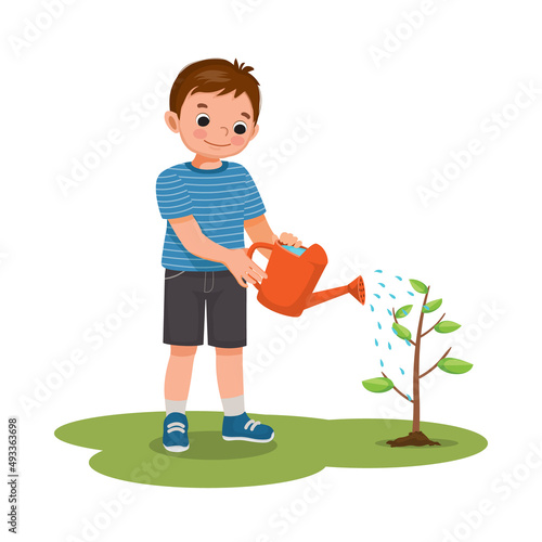 cute little boy watering plants flowers in the pot with watering can in the garden