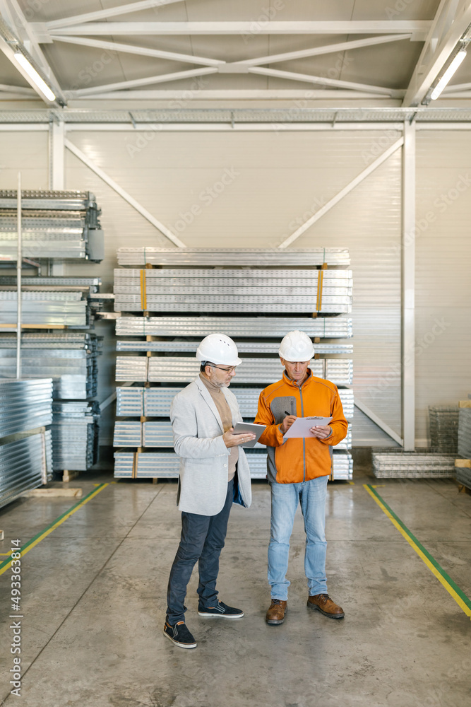 Manager Working With A Worker In A Factory