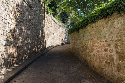 Man on a narrow street photo