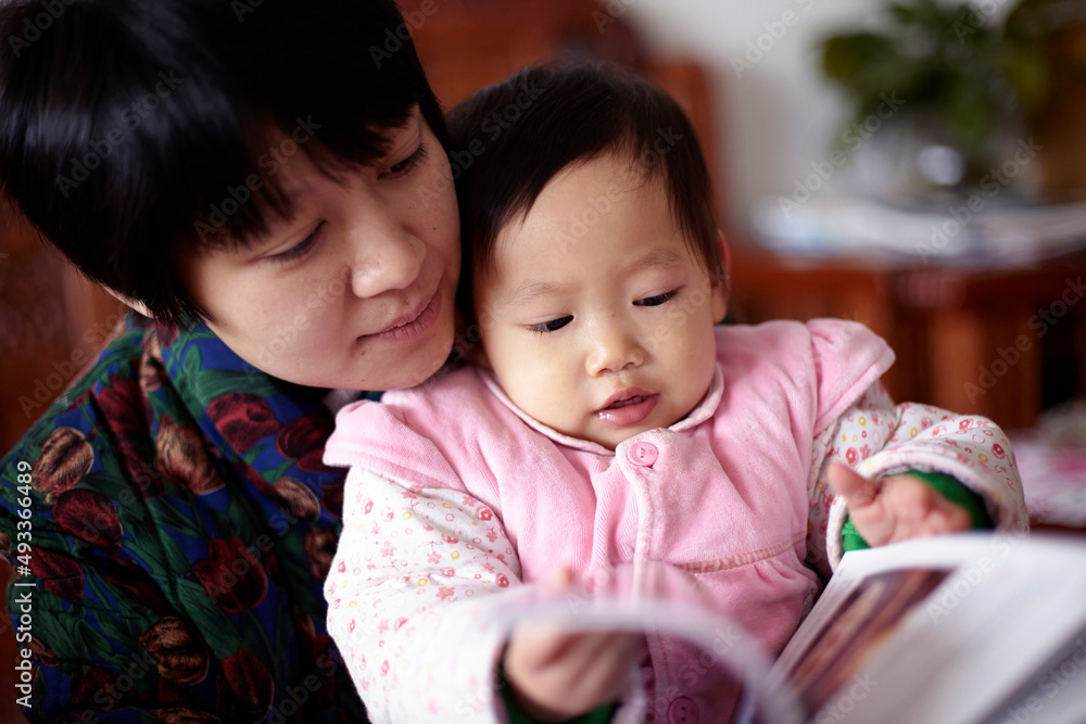 Cute asian baby and mother are reading picture book
Cute asian baby and mother are reading picture book