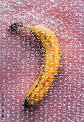 An overripe banana in a wrapper. photo
