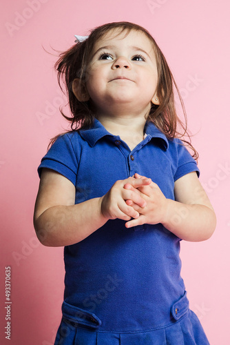 Little girl acting cute in studio