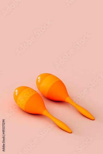 close up of colorful maracas on a pink background photo