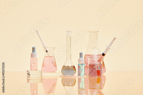 Volumetric laboratory glassware containing colored liquids photo