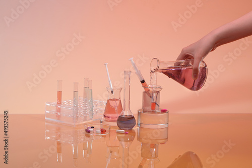 Scientific researcher or doctor pouring chemical substance test tube in laboratory. photo