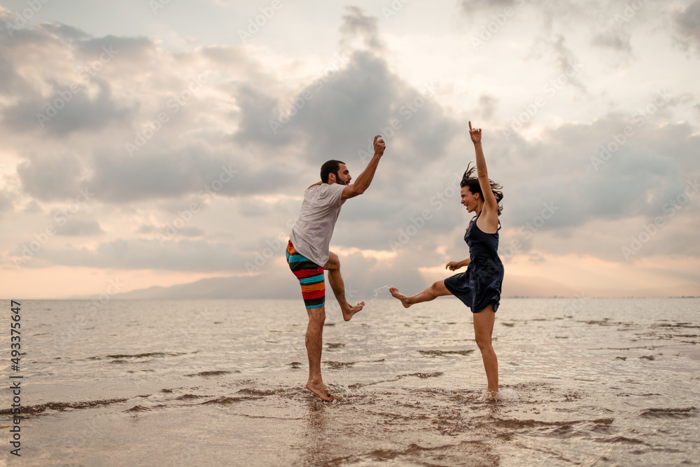 Couple dancing together on tropical beach Couple dancing together on tropical beach