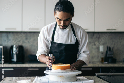 pastry chef assembling a cake photo