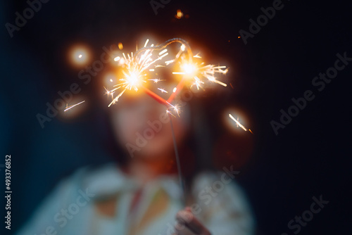 child playing with sparklers  photo
