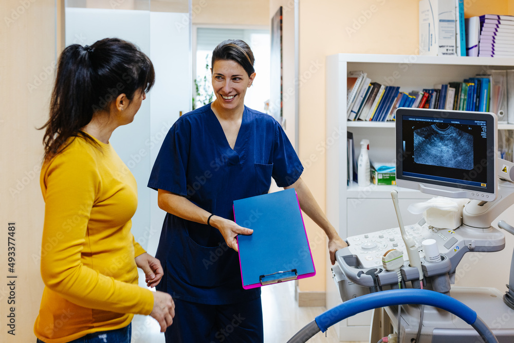 Female doctor preparing an ultrasound to a patient Female doctor preparing an ultrasound to a patient