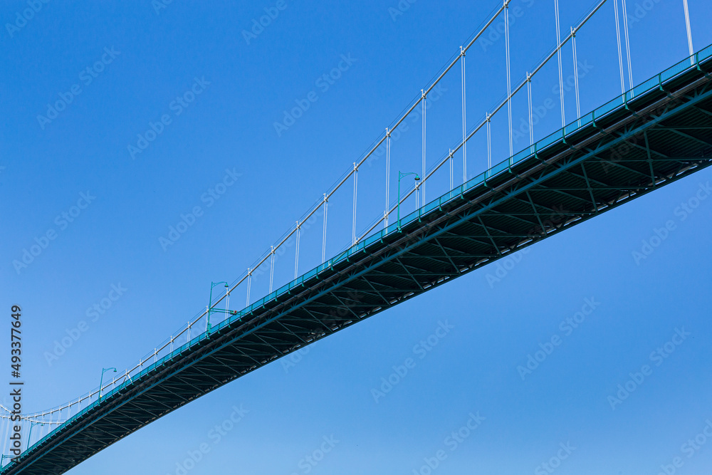 A suspension bridge with the sky in the background A suspension bridge with the sky in the background
