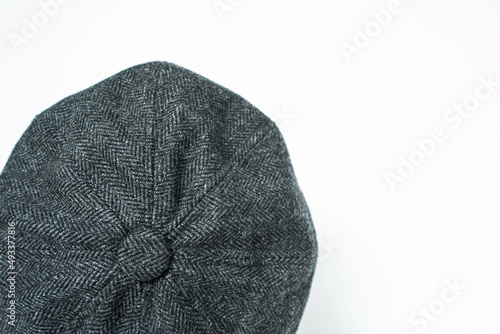 Detail of a classic eight-panel newsboy hat in herringbone wool photo