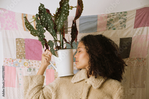 Fashion portrait of a woman with a plant vase photo