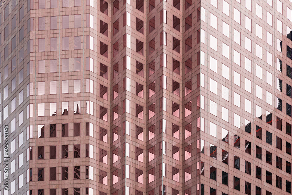 Pink building with glass windows forming patterns Pink building with glass windows forming patterns