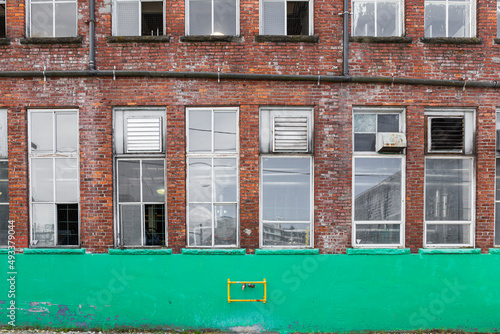 brick building with windows and green line below 