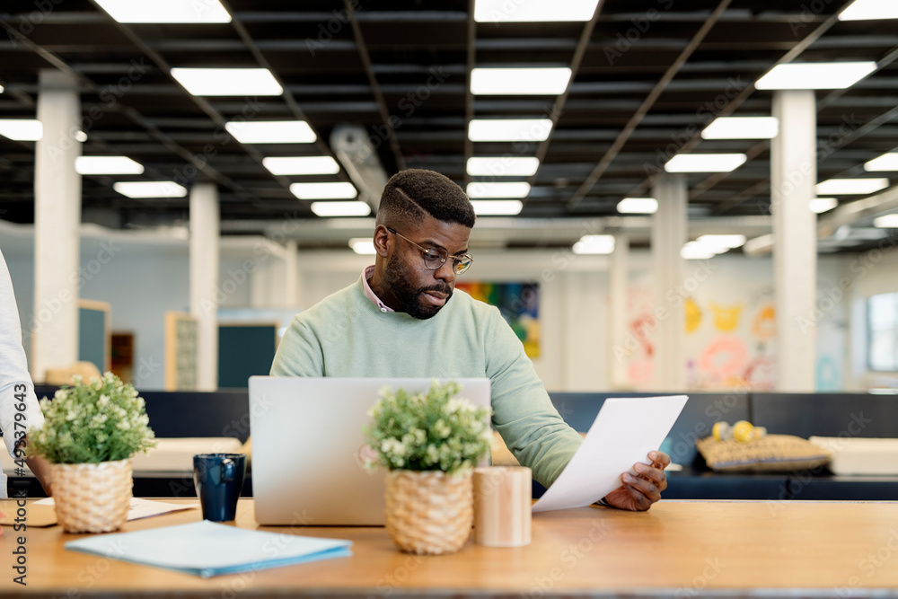 Male manager working in spacious workspace Male manager working in spacious workspace