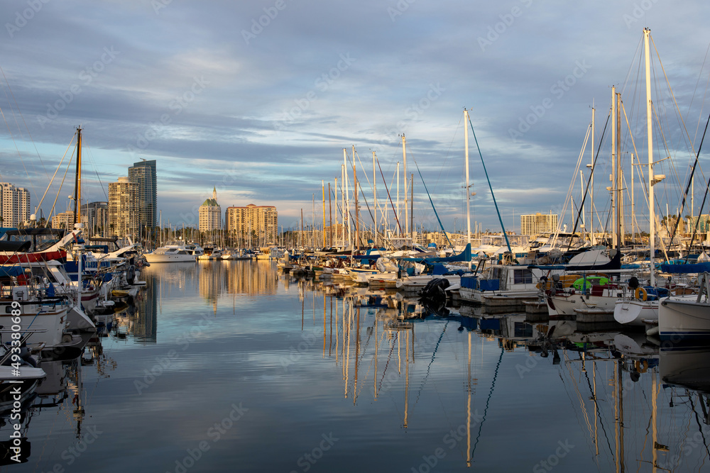 Marina in Long Beach, California, during beautiful sunset, boats and yachts on the water with reflection on the water